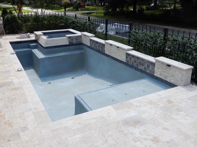 an empty pool with spa and retaining wall the concept to  Upgrade Your Swimming Pool